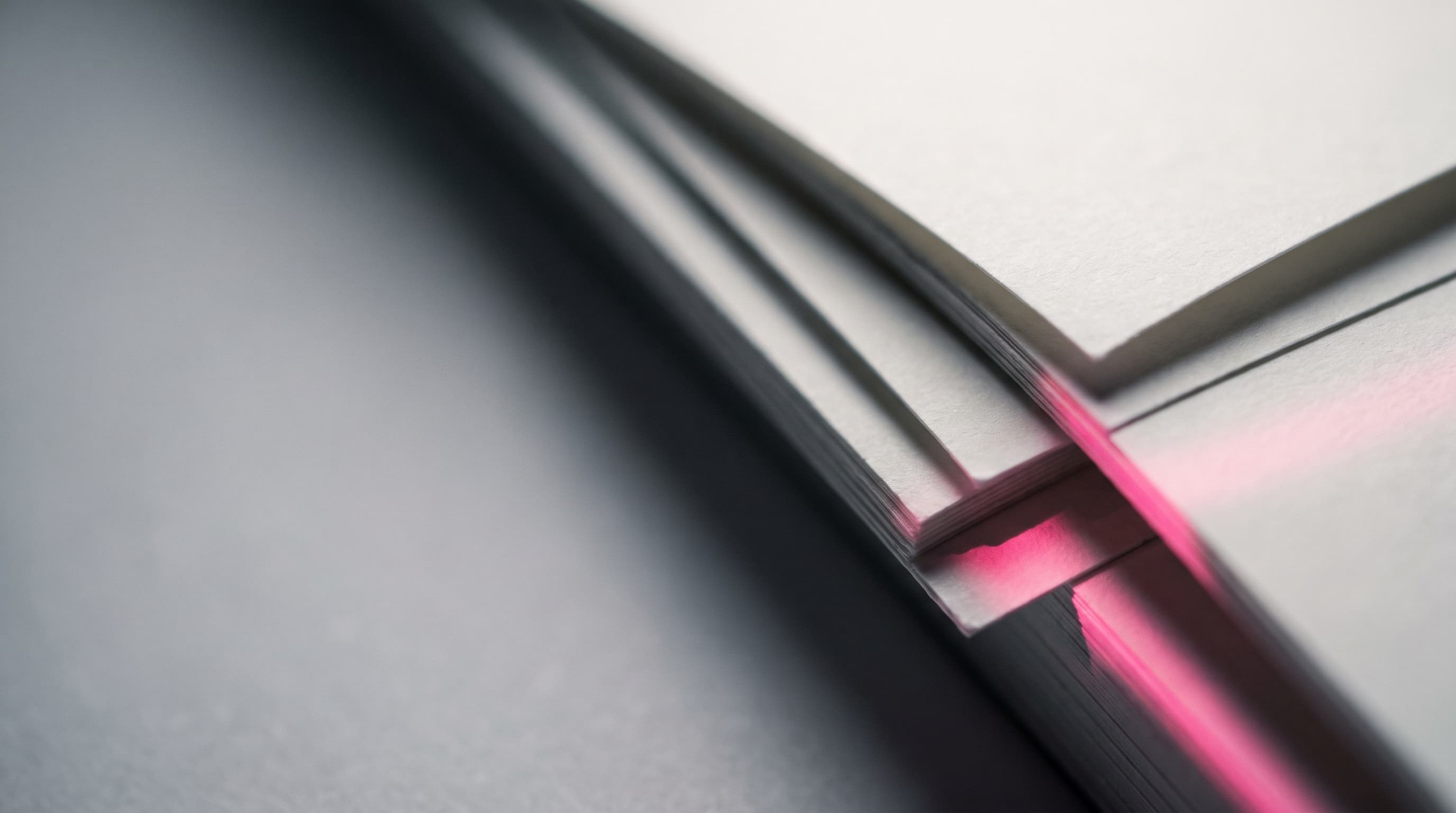 Layered paper texture with a pink light streak